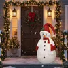 A festive Christmas scene featuring a large LED snowman decoration on a porch, adorned with Christmas lights and a wreath on the door. Voir les images du produit