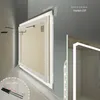 A close-up, angled view of a modern LED bathroom mirror, showcasing its illuminated edge and mounting hardware. Produktbild-Vorschau