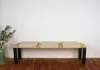 A bench with three beige seat cushions against a white wall. Anteprima dell’immagine prodotto