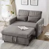 A gray sofa bed is shown in a living room setting, with a side table and lamp to the left, and books to the right. Produktbild-Vorschau