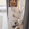 A decorative bust and dried flowers on a white surface, with curtains in the background. Produktbild-Vorschau