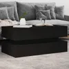 A black coffee table sits in front of a grey sofa. Anteprima dell’immagine prodotto