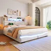 A modern bedroom with a white upholstered bed featuring LED lighting and a headboard with shelves. Podgląd zdjęcia produktu