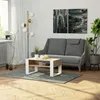A living room scene with a couch, coffee table, floor lamp, and artwork. Voir les images du produit