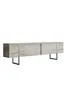 A long, low TV stand with a travertine-like finish and silver legs, presented against a white background. Anteprima dell’immagine prodotto