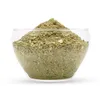 A clear, front-facing studio shot of a glass bowl filled with green powder. Náhľad obrázku produktu