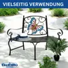 A metal garden bench with a butterfly design on the back, placed outdoors on a paved patio with plants and bushes in the background. Anteprima dell’immagine prodotto
