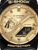 A close-up view of a gold and black G-Shock watch face. Produktbild-Vorschau