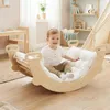 A child playing on a wooden climbing arch in a nursery room. Náhľad obrázku produktu