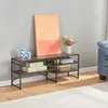 A TV stand with decorative items and artwork in a living room setting. Anteprima dell’immagine prodotto