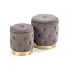 Two gray tufted ottomans with gold bases are shown against a white background. Produktbild-Vorschau