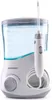 A white and blue water flosser station with a handle and hose. Produktbild-Vorschau