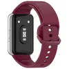 The back of a smartwatch with a burgundy strap is shown against a white background. Produktbild-Vorschau