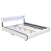A white bed frame with a blue LED light strip on the headboard, shown from a diagonal angle. Náhled obrázku produktu