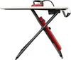 A red and black ironing board with a red iron on top, shown from the side. Produktbild-Vorschau