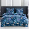 A bed with a floral patterned duvet and pillows. Náhled obrázku produktu
