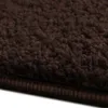 A close-up view of a dark brown shaggy carpet. Náhled obrázku produktu