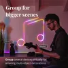 A man playing a guitar in front of a neon light shaped like a musical note. Produktbild-Vorschau