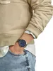 A person wearing a watch and casual clothing. Produktbild-Vorschau