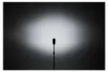 A studio shot of a flash unit on a stand, illuminated by its own light. Podgląd zdjęcia produktu