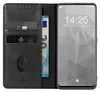 A black leather flip phone case with card slots and a euro banknote, next to a smartphone displaying a lock screen. Produktbild-Vorschau