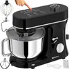 A black and silver stand mixer with various attachments is shown from a slightly elevated front-left angle against a white background. A hand is shown pressing a button on the mixer's digital display. Produktbild-Vorschau
