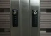 Close-up of two combination locks on a metallic surface, with textured gray panels on the sides. Náhled obrázku produktu