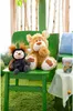 Two stuffed toys, a bear and a ladybug, sit on a green chair in a whimsical, forest-like setting. Podgląd zdjęcia produktu