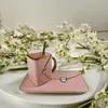 A pink teacup and saucer set with a spoon, surrounded by white flowers. Produktbild-Vorschau