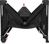 A black travel crib is shown from a slightly elevated, front-facing angle, with its sides partially folded inwards. Voir les images du produit