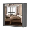A mirrored wardrobe reflecting a bedroom scene. Voir les images du produit