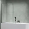 A modern bathroom with a bathtub and a glass shower screen. Produktbild-Vorschau