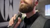 A man is trimming his beard with a Philips hair clipper. Anteprima dell’immagine prodotto