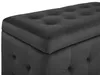 A close-up view of a tufted black velvet ottoman. Náhľad obrázku produktu