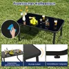 A black glass-topped coffee table with drinks and fruit on it, placed on a grassy lawn. Anteprima dell’immagine prodotto