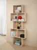 A modern, light wood bookshelf with various items displayed on its shelves, set against a neutral wall. Voir les images du produit