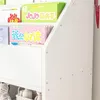 A close-up view of a white bookshelf filled with children's books. Náhled obrázku produktu