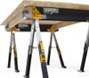 A close-up view of two TOUGHBUILT sawhorse/jobsite tables supporting a wooden board. Anteprima dell’immagine prodotto
