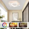 A modern living room with a square LED ceiling light, a framed botanical print on the wall, and baskets of fruit. Voir les images du produit