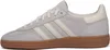 A side view of a grey Adidas Handball Spezial sneaker with cream stripes and a brown sole. Voir les images du produit