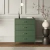 A green dresser with four drawers stands in a room with molding on the walls. A modern lamp with a spherical bulb sits on top of the dresser, next to a stack of books. A vase with branches is on a dark pedestal to the right. Anteprima dell’immagine prodotto