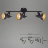 A black track light fixture with three adjustable spotlights, shown against a plain gray background. A technical drawing with dimensions is displayed below the fixture. Produktbild-Vorschau