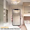 A hand holding a smartphone showing a ceiling light in a room with a bunk bed and desk. Produktbild-Vorschau