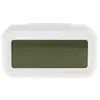 A white digital alarm clock with a dark green LCD screen is shown against a white background. Náhled obrázku produktu