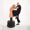 A man is practicing martial arts with a BOB dummy. Podgląd zdjęcia produktu