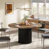 A dining room scene with a round wooden table and chairs, set for a meal. Produktbild-Vorschau