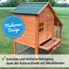 A wooden chicken coop with a pull-out tray for cleaning, set up on a grassy lawn. Produktbild-Vorschau