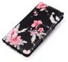 A black flip phone case with a floral hibiscus pattern. Produktbild-Vorschau