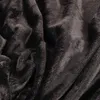 A close-up view of a dark gray, fluffy blanket. Produktbild-Vorschau