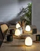 A table setting with mugs, lamps, and breadsticks. Produktbild-Vorschau